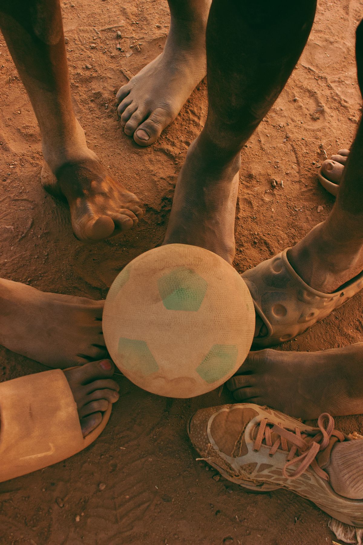 Bare feet gathered around a worn football
