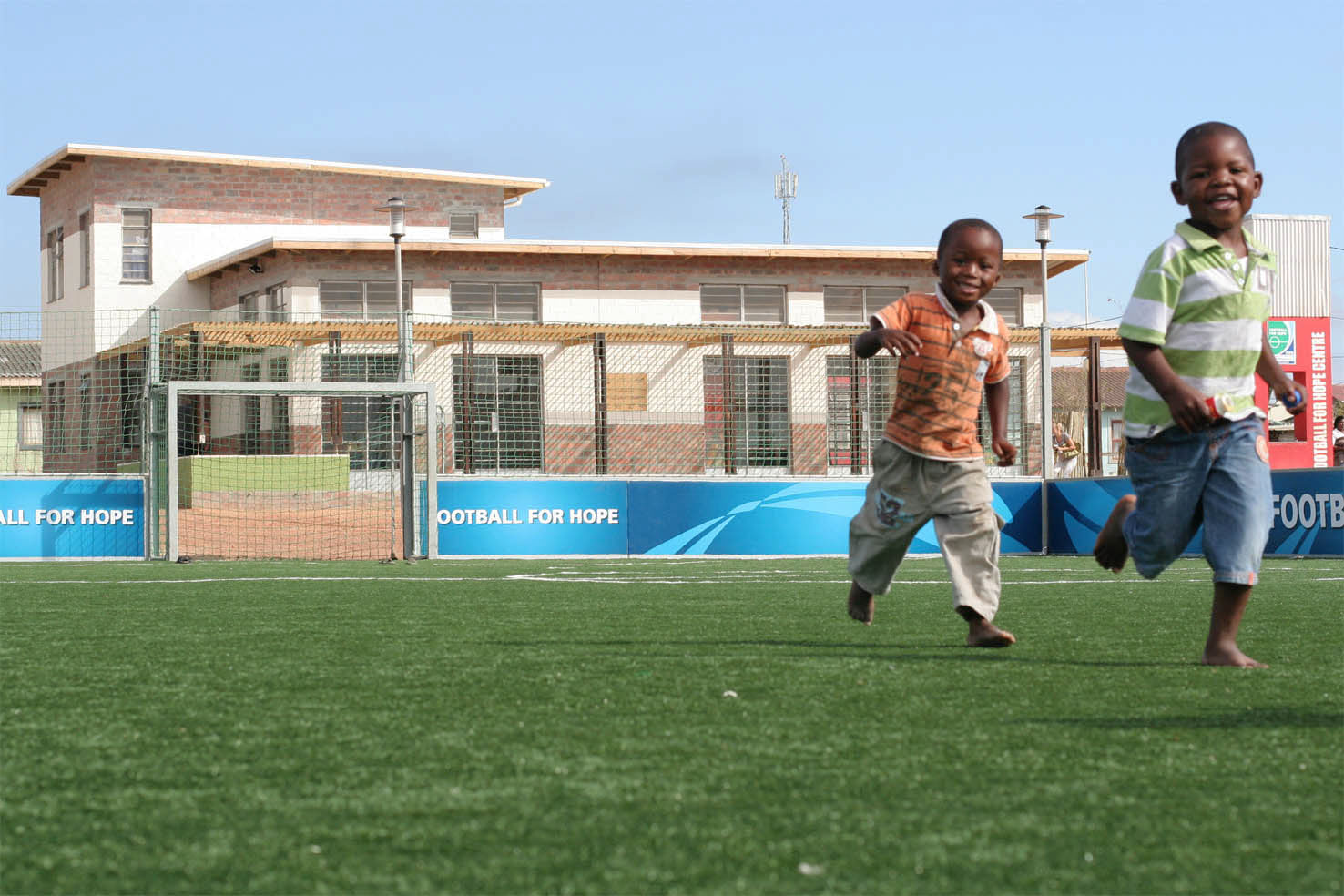 Children playing on the pitch of the Football for Hope Centre in Khayelitsha